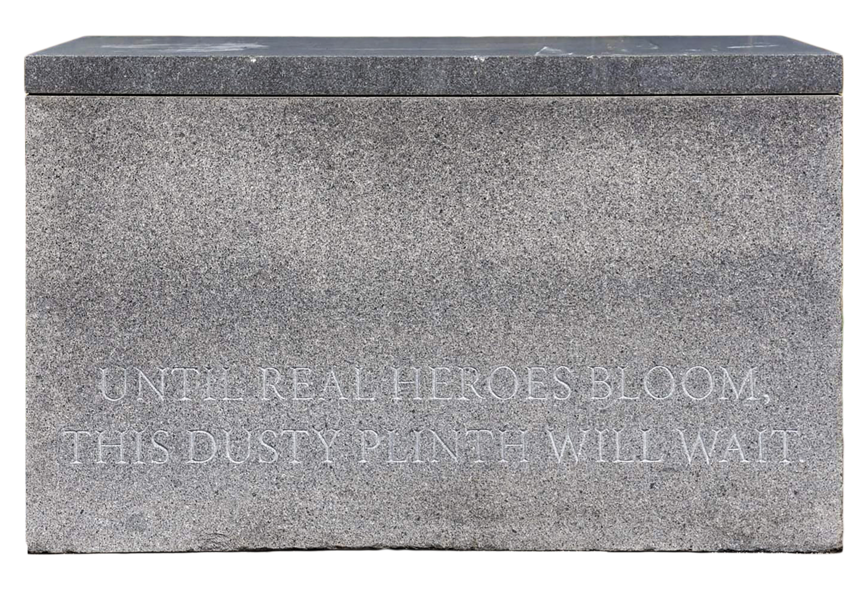 A gray stone slab inscribed with the words, "Until real heroes bloom, this dusty plinth will wait."