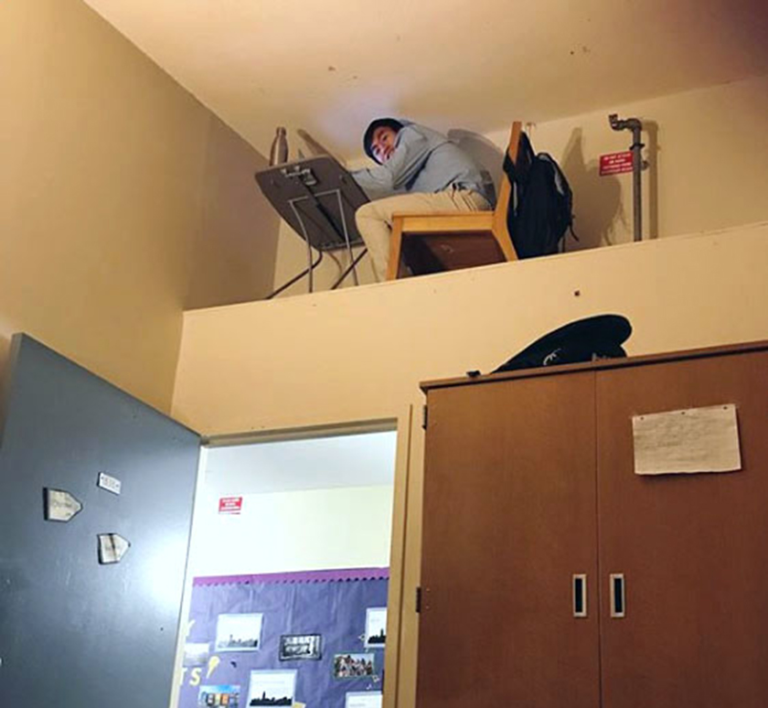 student at desk in dorm