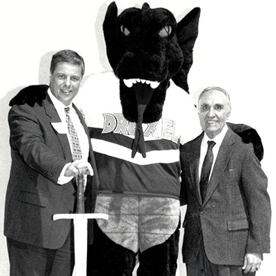 drexel mascot posing with two people