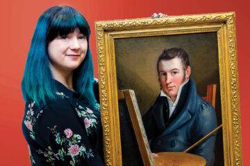 Someone with blue hair and bangs holding up a gold framed painting of Francis Martin’s self-portrait