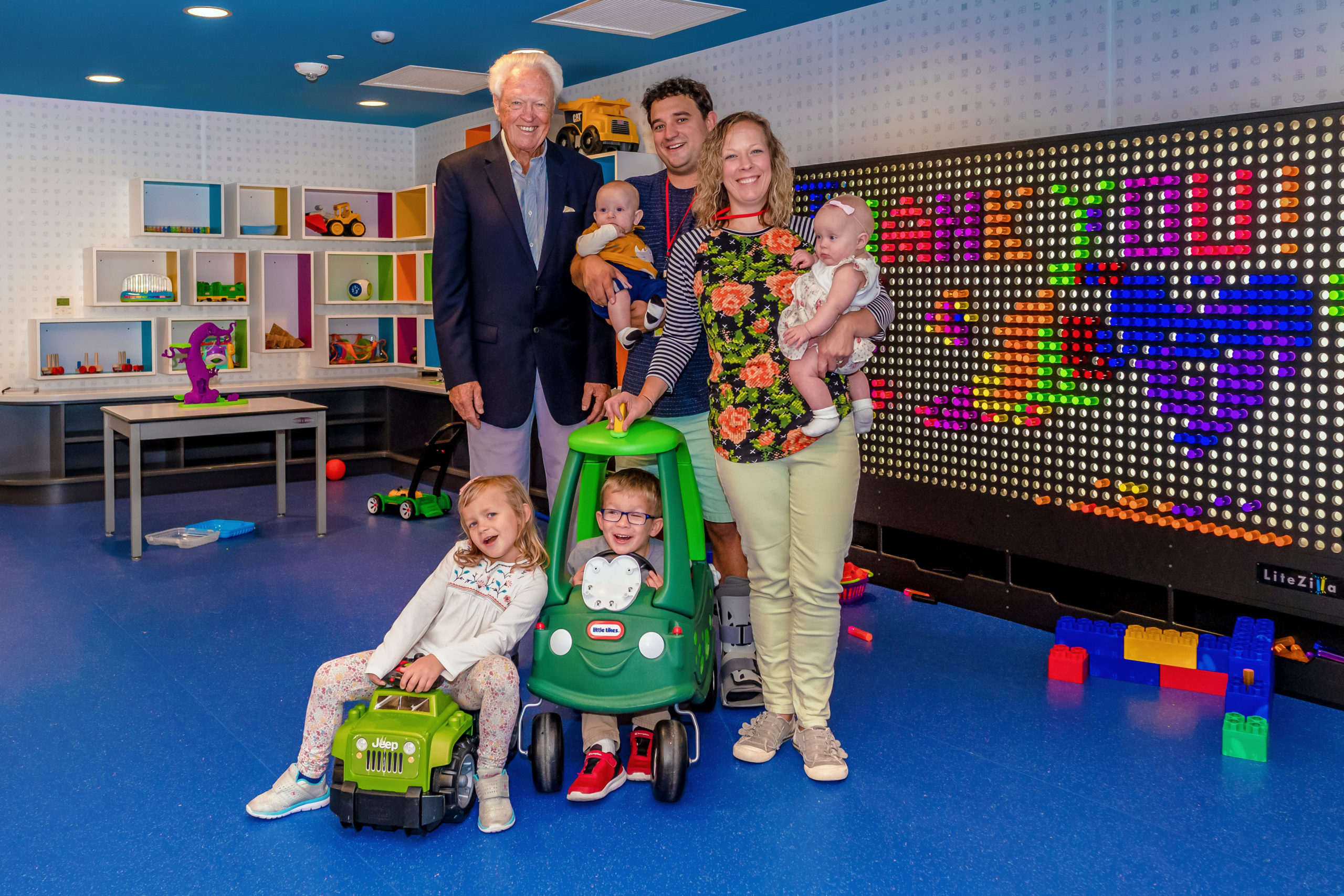 Stan Lane standing with a family