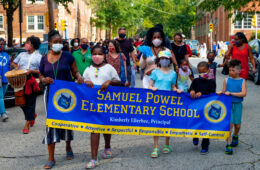students holding a' samuel powel elementary school' banner
