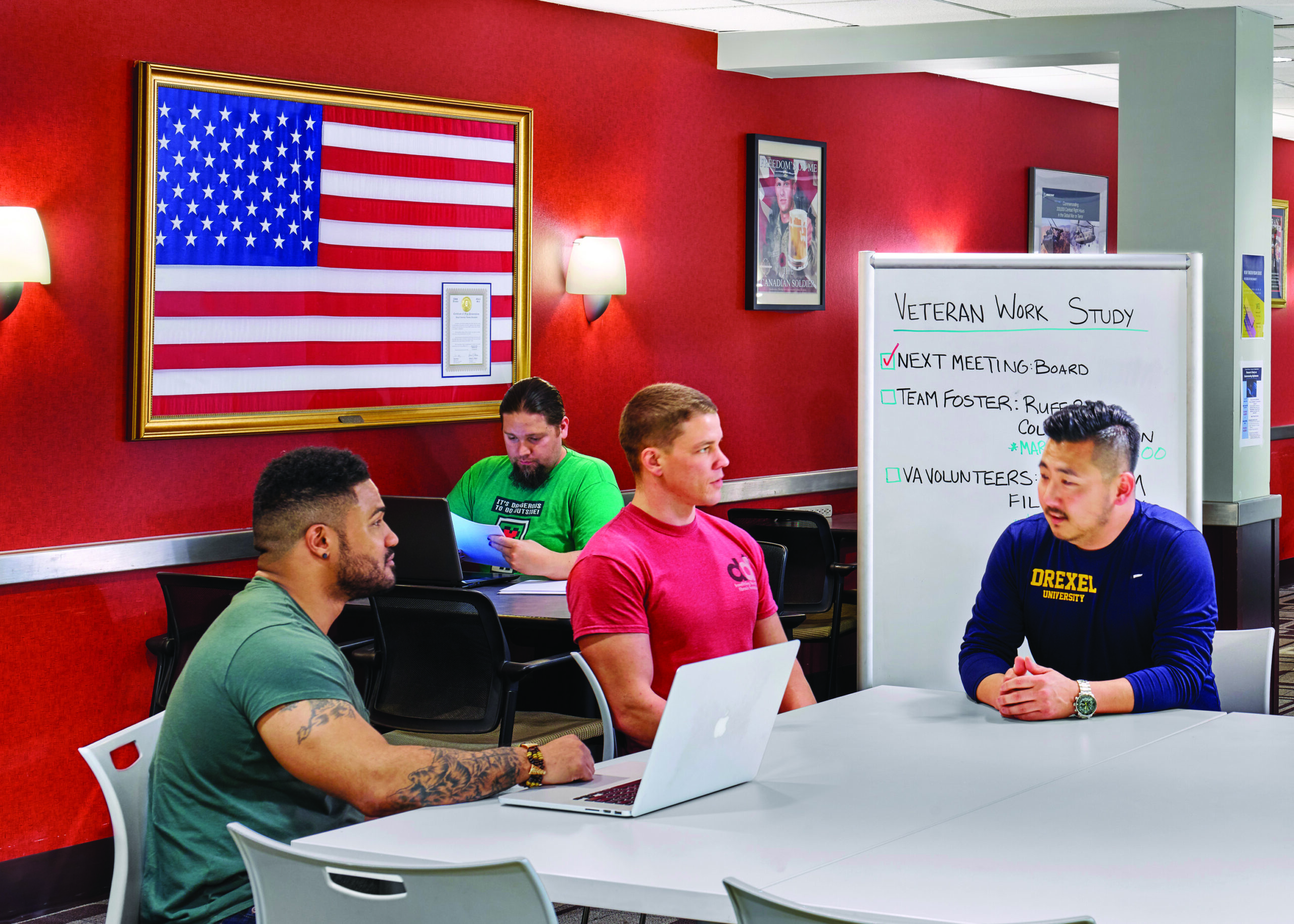 A group of student veterans study and collaborate in a digital mockup of the Student Veterans Lounge.