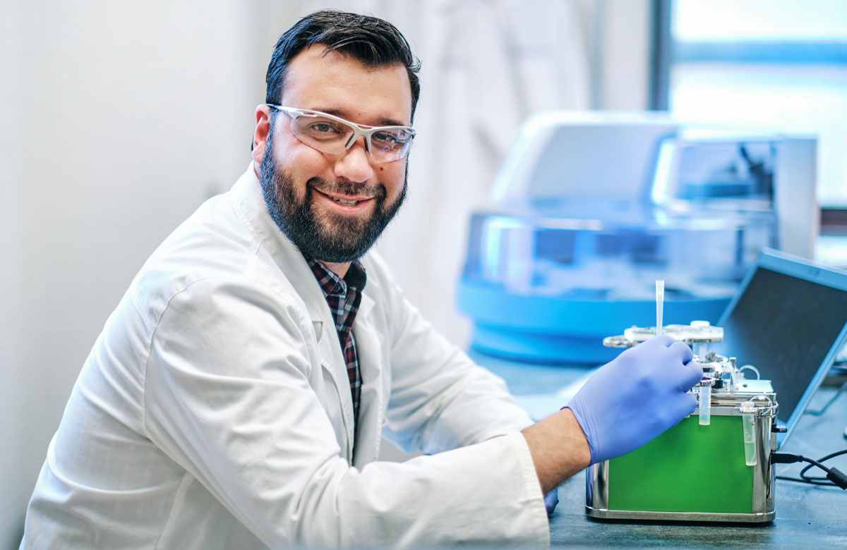 King Fisher wearing a white coat in a lab