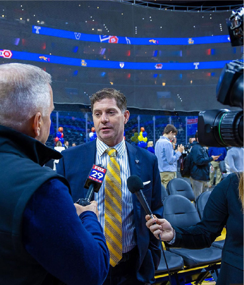 Men's basketball coach Zach Spiker addresses the media